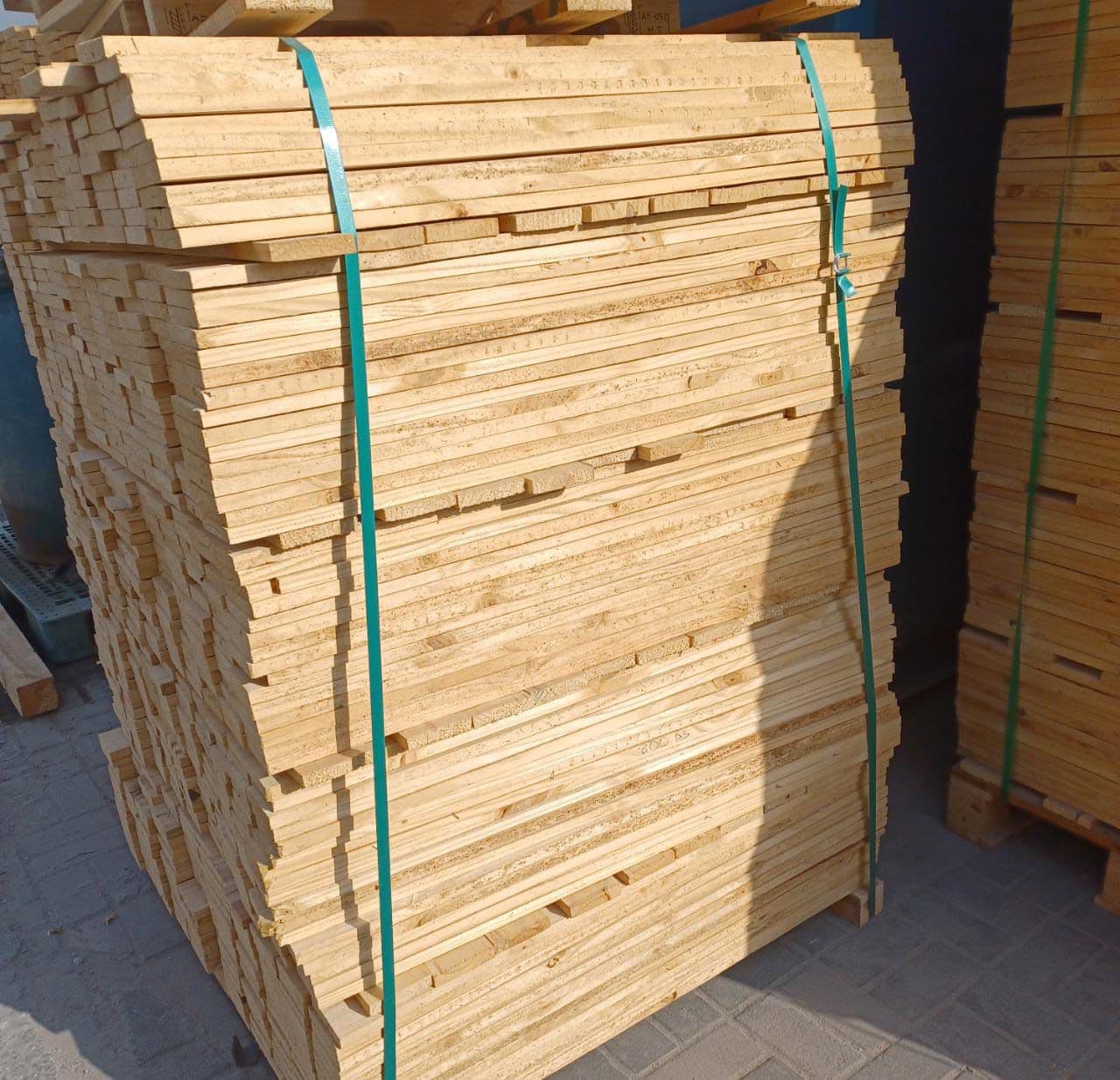 Strapped bundles of cut pallet boards ready for assembly